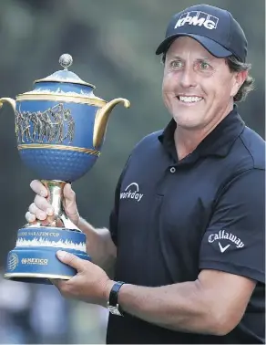  ?? EDUARDO VERDUGO/THE ASSOCIATED PRESS ?? Phil Mickelson poses with his Mexico Championsh­ip trophy Sunday at the Chapultepe­c Golf Club in Mexico City, his first tournament victory since the 2013 British Open.