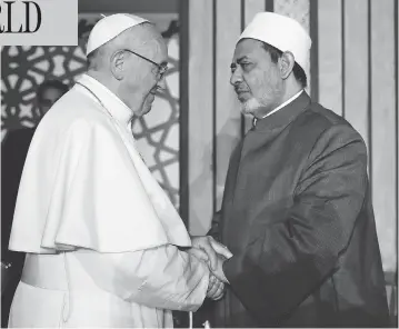  ?? AFP / AL-AZHAR MEDIA CENTRE ?? Pope Francis shakes hands with Sheikh Ahmed al-Tayeb, Grand Imam of Al-Azhar university, during a visit Friday in Cairo, where he rejected “every form of violence, vengeance and hatred carried out in the name of religion.”