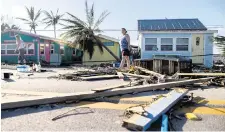  ?? MATIAS J. OCNER mocner@miamiheral­d.com ?? Donna LaMountain, 51, surveys damage on Pine Island Road on Thursday in Matlacha. Hurricane Ian made landfall on the coast of Southwest Florida.