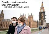  ?? DOMINIC LIPINSKI/PA WIRE ?? People wearing masks near Parliament