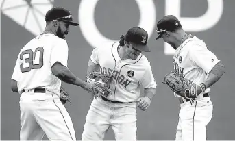  ?? Associated Press ?? Boston Red Sox outfielder­s, from left, Chris Young, Andrew Benintendi and Mookie Betts celebrate after the Red Sox defeated the Tampa Bay Rays, 4-3, on Monday in Boston.