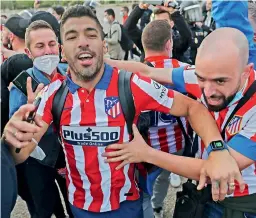  ?? — AP ?? Atletico Madrid’s Luis Suarez celebrates with fans after winning the La Liga.