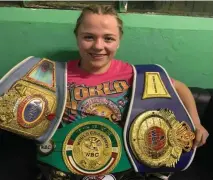  ??  ?? Katelynn Phelan shows off her title belts after her superb victory in Germany on Saturday night