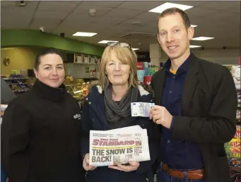  ??  ?? In Ballyculla­ne Service Station were Jan Sinnott, manager, Tish Wall, Ballyculla­ne, winner €20 and David Looby, New Ross Standard.