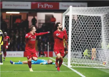  ?? Reuters ?? Liverpool’s Mohammad Salah celebrates scoring their first goal with Xherdan Shaqiri against Watford at the Vicarage Road, Watford, yesterday. Liverpool won 3-0.