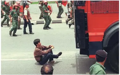  ??  ?? Blast from the past: Tian Chua defying the riot police by sitting in front of a water cannon truck during the Reformasi movement 20 years ago.