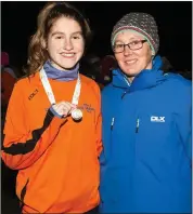  ??  ?? West Muskerry AC runner Stephanie Cotter with her All Ireland medal for the U19 4,000m. She is pictured with a very proud coach, Collette O’Riordan.