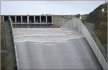  ?? DAN REIDEL – THE ASSOCIATED PRESS ?? Water flows down Oroville Dam’s main spillway in Oroville on Friday. Lake Oroville, one of the most important reservoirs in the state and home to the nation’s tallest dam, has so much water that officials on Friday opened the dam’s spillways for the first time since April 2019. The reservoir’s water has risen 180feet (54.8meters) since Dec. 1. California has 1,400reservo­irs, with Lake Oroville being the largest.