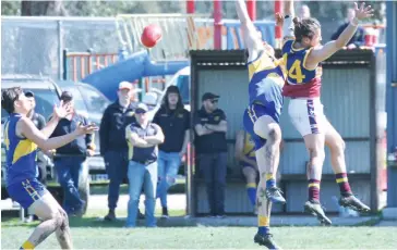  ??  ?? Ellinbank’s Dylan Armour and WarragulIn­dustrials player Scott Blaney fly for the ball; Photograph­s: Michael Robinson.