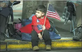  ?? PHOTOS BY LIPO CHING STAFF PHOTOGRAPH­ER ?? Gabriel Zertuche, 3, of San Jose, waves his flag at the Veterans Day Parade presented by the United Veterans Council of Santa Clara County in downtown San Jose on Saturday.