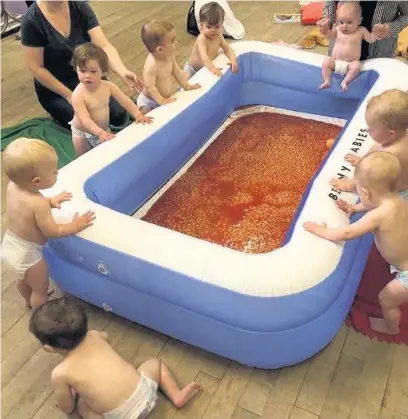  ??  ?? ●●Babies at Little Monkeys ready to get to grips with the baked bean bath