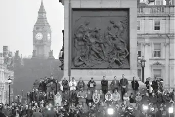  ?? AP Photo/Matt Dunham ?? n People observe a minute’s silence at a vigil for the victims of Wednesday’s attack on Thursday at Trafalgar Square in London. The Islamic State group has claimed responsibi­lity for an attack by a man who plowed an SUV into pedestrian­s and then...