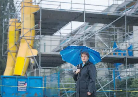  ?? GERRY KAHRMANN ?? Katherine Munro stands outside her Coquitlam condo building last week. The building was damaged in a massive blaze three years ago, but repairs are almost finished. Coupled with rising prices, the restoratio­n has pushed Munro’s 2018 assessment to...