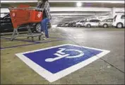  ?? Mark Boster Los Angeles Times ?? AN UNDERCOVER officer with the DMV waits next to a disabled parking spot in Glendale Galleria.