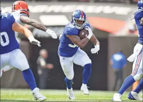  ?? Jason Miller / Getty Images ?? The Giants’ Elijhaa Penny runs for a gain during the second quarter against the Browns ina preseason game on Sunday in Cleveland.