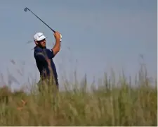  ??  ?? WALK IN THE PARK: Dustin Johnson plays his second shot at the 12th hole in Sunday’s final round.