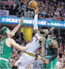  ?? [AP PHOTO] ?? The Cavaliers’ LeBron James (23) attempts to get a shot off between the Celtics’ Kelly Olynyk (41) and Jae Crowder (99) on Sunday during the second half of Game 3 of the Eastern Conference finals in Cleveland.