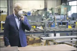  ?? MATT SLOCUM — THE ASSOCIATED PRESS FILE ?? Democratic presidenti­al candidate and former Vice President Joe Biden adjusts his mask Thursday during a tour of McGregor Industries, a metal fabricatin­g facility in Dunmore, Pa.