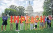  ?? AFP ?? ■ Protesters hold up letters reading ‘impeach’ in front of the parliament building in US Capitol, Washington DC.