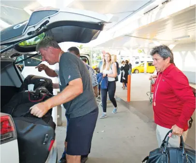  ?? Photo: Fiji Internatio­nal ?? Ernie Els (left) loads his baggage while arriving at Nadi Internatio­nal Airport on July 30, 2018.