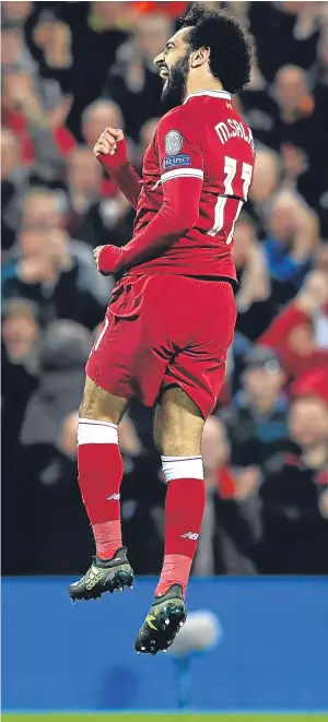  ??  ?? ON A HIGH: Mohamed Salah hits the heights after scoring Liverpool’s second goal against Sevilla at Anfield last night