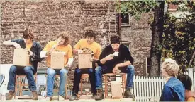  ?? BEN & JERRY’S ?? Bruce Vielmetti (second from left) takes part in an ice-cream-eating contest outside Ben & Jerry’s original store in 1978.