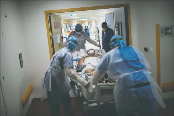  ?? (AP/Daniel Cole) ?? A 60-year-old covid-19 patient is transferre­d to the main ICU at the La Timone hospital in Marseille, southern France, from a makeshift wing which couldn’t support both the dialysis and respirator machines necessary for his worsening condition. France is more than two weeks into its second coronaviru­s lockdown, and intensive care wards have been over 95% capacity for more than 10 days now.