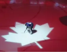  ?? STEVE RUSSELL/TORONTO STAR ?? The ice turns patriotic colours as goalie Jonathan Bernier listens to Canada’s national anthem before a Leafs home game.