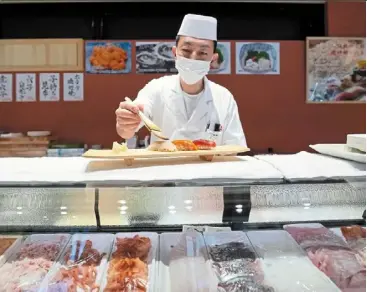  ?? ?? a sushi chef preparing a plate at toyosu Senkyaku banrai, an edo period-themed hot spring complex at toyosu Market. — ap
