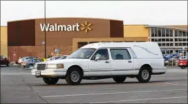  ?? ERIC GAY / ASSOCIATED PRESS ?? A hearse waits in the parking lot of the Walmart store where the tractor-trailer was parked. The driver of the rig, 60-year-old James Mathew Bradley Jr. of Clearwater, Fla., was in custody and will be charged, officials said.