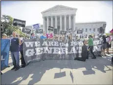  ?? PABLO MARTINEZ MONSIVAIS / AP 2014 ?? Demonstrat­ors in Washington await the Supreme Court verdict in a case that weighs the religious rights of employers and the right of women to the birth control of their choice.