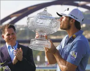  ?? ERIC GAY AP ?? Sam Burns kisses his trophy after defeating Cameron Young in the final match at the Match Play Championsh­ip. In the semis he beat Scottie Scheffler on the 21st hole.