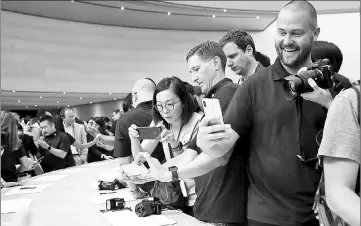  ??  ?? Checking out a new iPhone X during an Apple special event at the Steve Jobs Theatre on the Apple Park campus on Sept 12 in Cupertino, California. — AFP photo