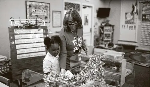  ?? Photos by Marie D. De Jesús / Staff photograph­er ?? SpringWood­s Christian Academy teacher Patty Pampell takes a look at pre-kindergart­en student Aria Lawson’s work.