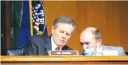  ?? STEFANI REYNOLDS/POOL VIA AP ?? Sen. Steve Daines, R-Mont., speaks to a member of his staff during a Senate Finance Committee hearing on the FDA foreign drug manufactur­ing inspection process in June.