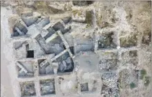  ??  ?? Aerial photo of the Early Bronze Age site at Tell-es Safi, Israel. The circle indicates the location of the house where four donkey skeletons were discovered."