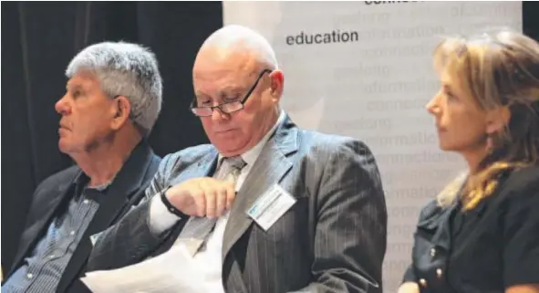  ??  ?? PAY DAY: Geelong mayor John Mitchell studies his notes as he campaigns to get his job back. He is flanked by candidates Graeme Robin and Stephanie Asher.