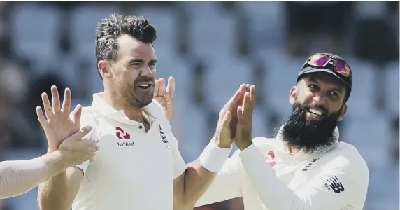  ??  ?? England’s James Anderson celebrates taking the wicket of West Indies’ captain Kraigg Brathwaite with teammate Moeen Ali.