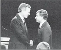  ?? Lennox McLendon Associated Press ?? THE HIGHEST OFFICE Bush meets Democrat Michael Dukakis on stage before their final debate in the 1988 presidenti­al race. Bush won the prize.