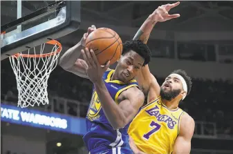  ?? Thearon W. Henderson / Getty Images ?? After spending the majority of his first two profession­al seasons in the G League, Warriors center Damian Jones (with ball) is holding his own against some of the NBA’s top centers.