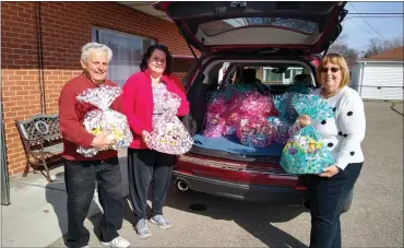  ?? COURTESY DENISE RODI ?? Chet Klos, Cheryl Sekloch and Denise Rodi from Amazing Grace Lutheran Church in Warren help the Warren Rotary Club every Easter put together special Easter baskets for children in Warren, Roseville and Flint whose families could not otherwise afford them.