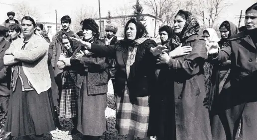  ??  ?? People grieve over the massacre of ethnic Azerbaijan­is by Armenians in the town of Khojaly, Nagorno-Karabakh, Azerbaijan, February 1992.