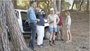  ??  ?? German Chancellor Angela Merkel (second left) looks through a pair of binoculars next to Spain’s Prime Minister Pedro Sanchez (left), in the Donana National Park accompanie­d by Merkel’s husband, Joachim Sauer, and Sanchez’s wife, Begona Gomez.