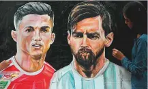  ?? AFP ?? ■ An art school student gives final touches to painting of Christiano Ronaldo and Lionel Messi in Mumbai.