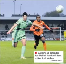  ?? DAVID HOLMES ?? Gateshead defender Jon Mellish holds off Bees striker Josh Walker