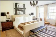  ?? AP/HEATHER TALBERT/Nate Berkus Associates ?? This undated photo shows a master bedroom designed by Lauren Buxbaum Gordon. The natural fiber rug adds warmth and softness around the bed, while a smaller throw rug adds a touch of bold pattern.