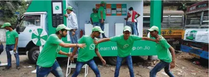  ?? - Reuters ?? ROAD SHOW: WhatsApp-Reliance Jio representa­tives perform in a street play during a drive by the two companies to educate users, on the outskirts of Kolkata, India, October 9, 2018.