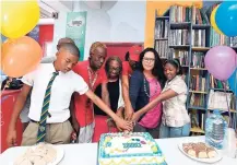  ?? CONTRIBUTE­D PHOTOS ?? Saffrey Brown (second from right), general manager, JN Foundation, celebrates with members of The Kairos Network source, August Town team, a community resource franchise developed by the JN Foundation a decade ago to empower communitie­s to take charge...