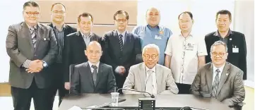  ??  ?? Masing (seated, centre) – flanked by Liwan (seated, right) and Cassidy – joins others in a group photo after the briefing. Also seen are (standing, from third left) Alexander, Jamit, Allen, Chukpai and Joseph.