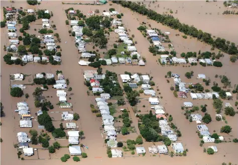 ?? — Reuters ?? Houses are surrounded by floodwater­s brought on by Cyclone Debbie in Rockhampto­n, Australia,on Thursday.